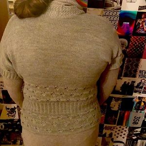 This is two pieces a turtleneck and short sleeve complementary cardigan